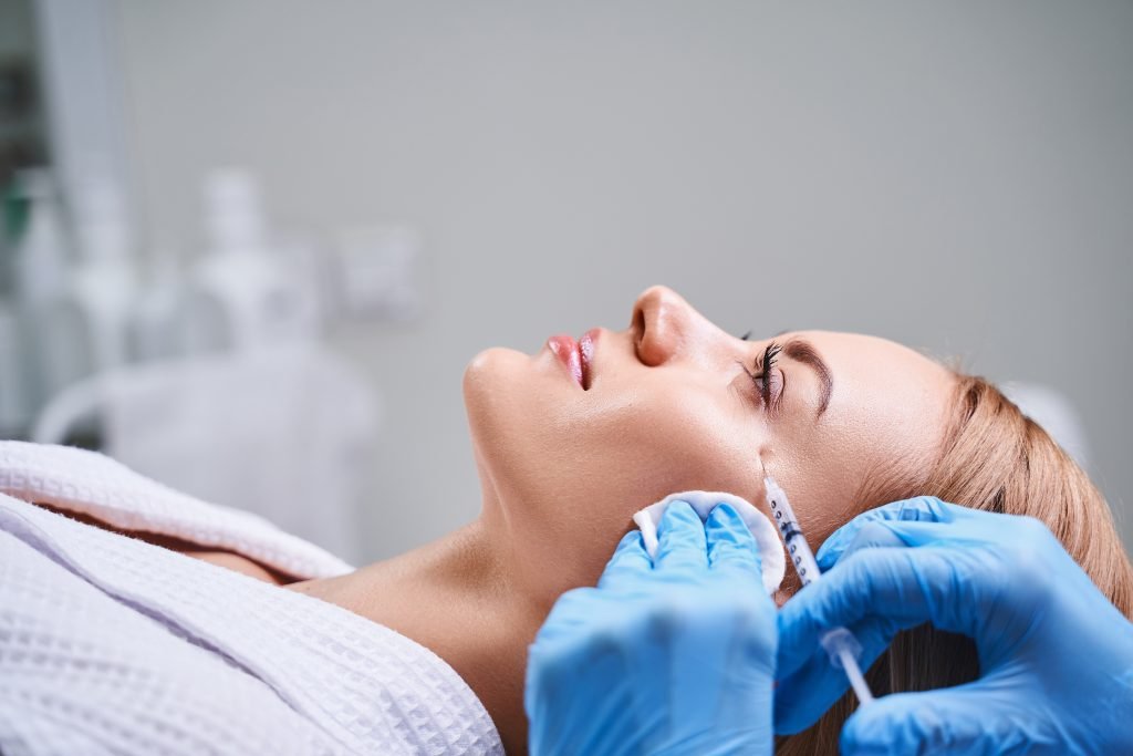 Female is receiving botox injections stock photo